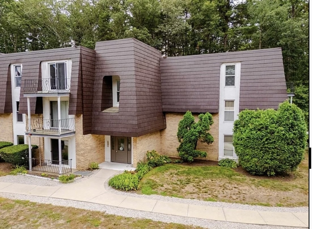 8 Shadowbrook Lane, Unit 38 Milford, MA 01757 - Photo 2 of 16 a front view of a house with garden