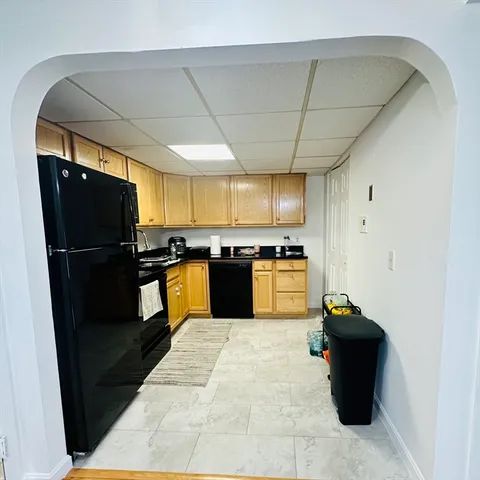 a kitchen with a refrigerator and a stove top oven