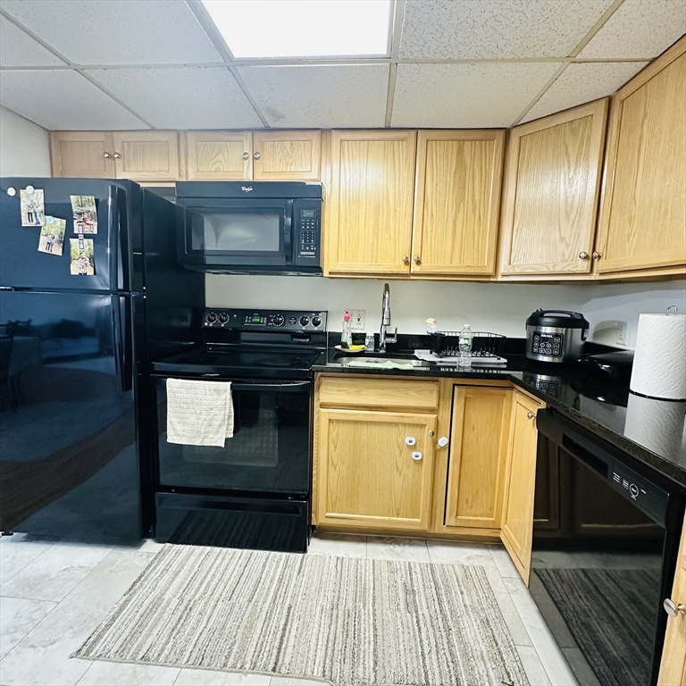 8 Shadowbrook Lane, Unit 38 Milford, MA 01757 - Photo 7 of 16 a kitchen with stainless steel appliances granite countertop a stove a sink and a microwave