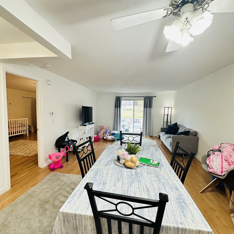 8 Shadowbrook Lane, Unit 38 Milford, MA 01757 - Photo 8 of 16 a living room with furniture and a flat screen tv