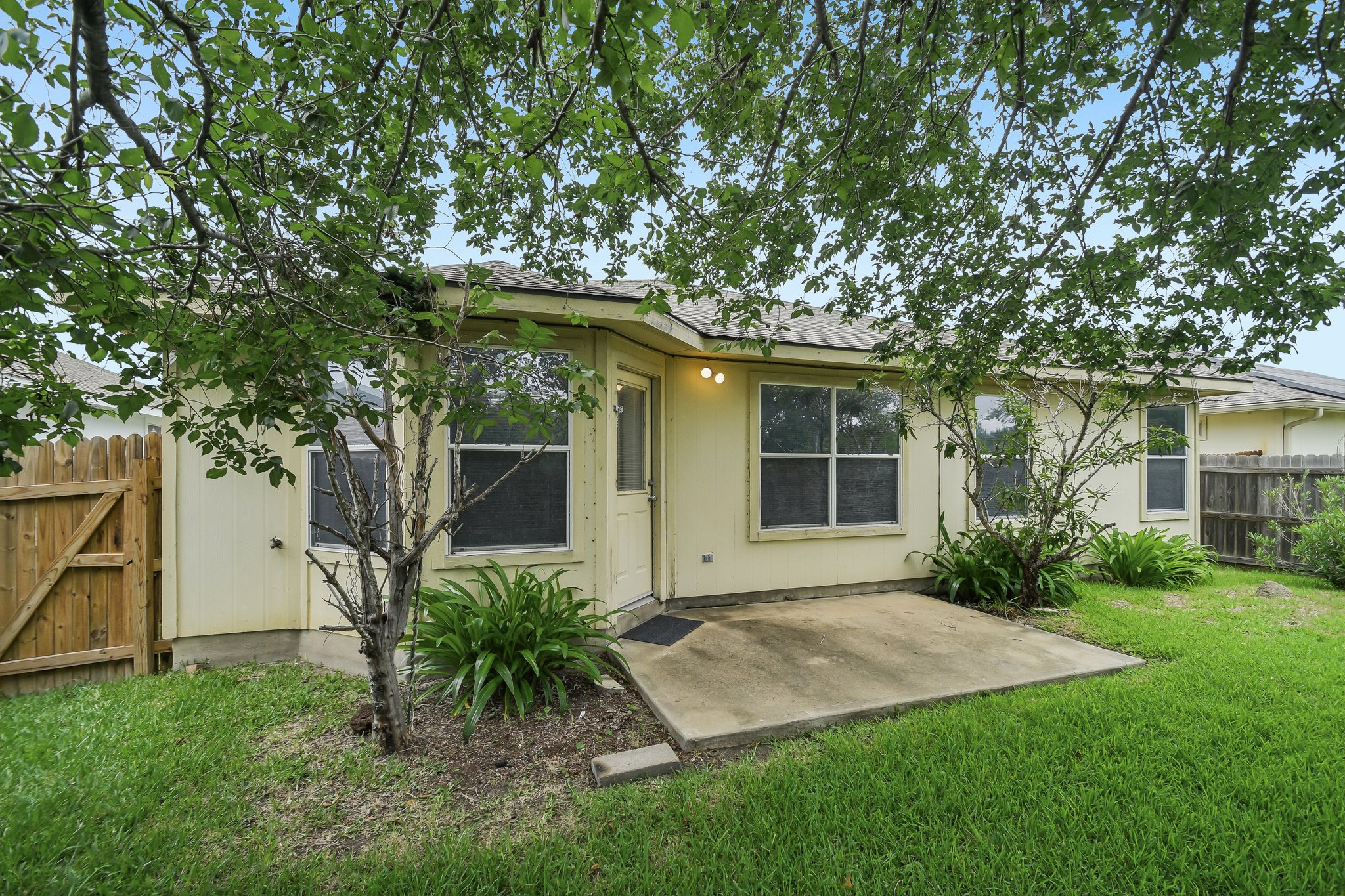 610 Lavaca Loop Elgin, TX 78621 - Photo 35 of 37 A secluded patio and private yard offer a quiet outdoor retreat.