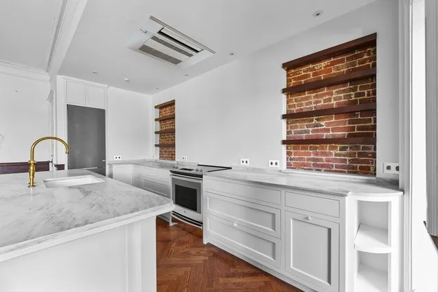 a kitchen with granite countertop a stove and a sink