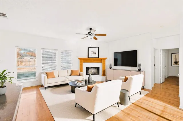 a living room with fireplace furniture and a flat screen tv