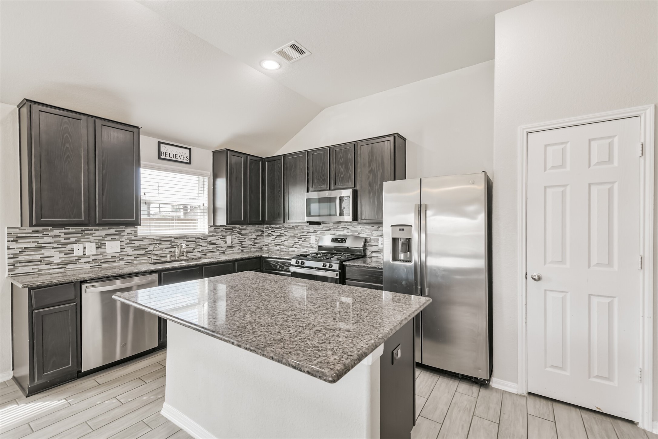 3127 Everwood Trail Rosenberg, TX 77471 - Photo 11 of 23 The spacious kitchen features large island with breakfast bar, stainless steel appliances and gorgeous granite counters