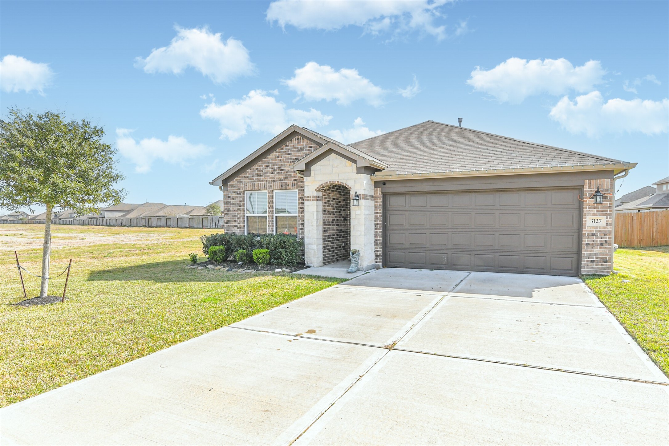 3127 Everwood Trail Rosenberg, TX 77471 - Photo 2 of 23 Large double-wide driveway, stone and brick facade and lush landscaping.
