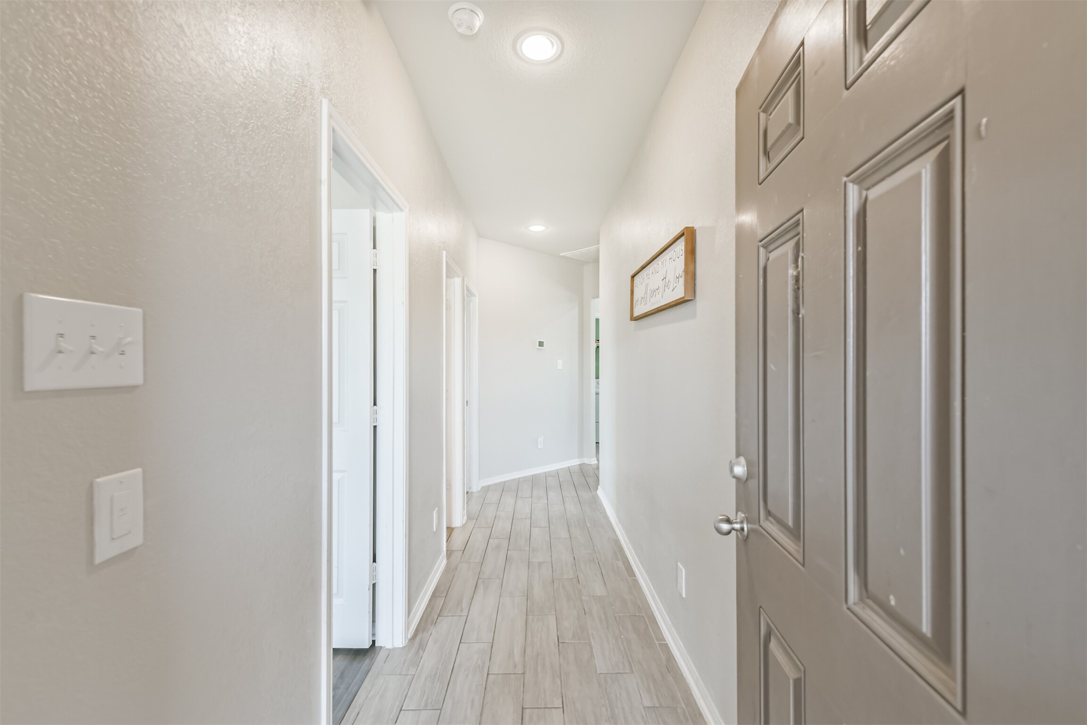3127 Everwood Trail Rosenberg, TX 77471 - Photo 3 of 23 Enter to luxury vinyl plank floors and a long hallway leading past the guest rooms.