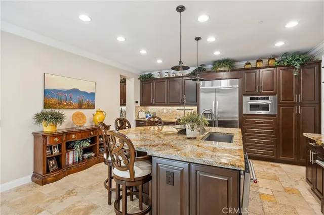 a kitchen with granite countertop stainless steel appliances and wooden cabinets