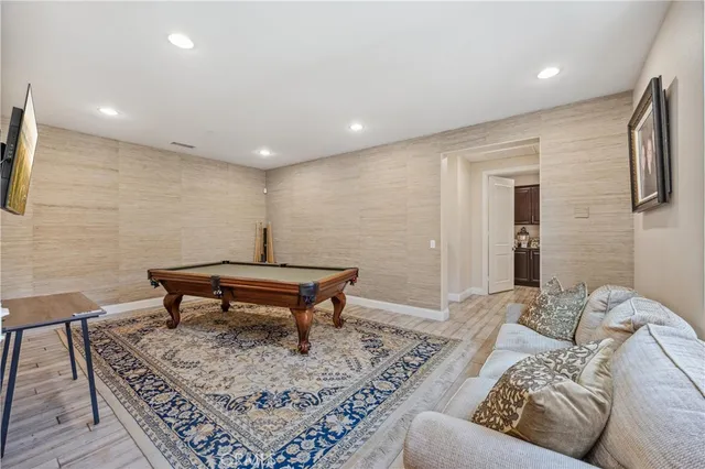 a bedroom with a bed and dresser with mirror