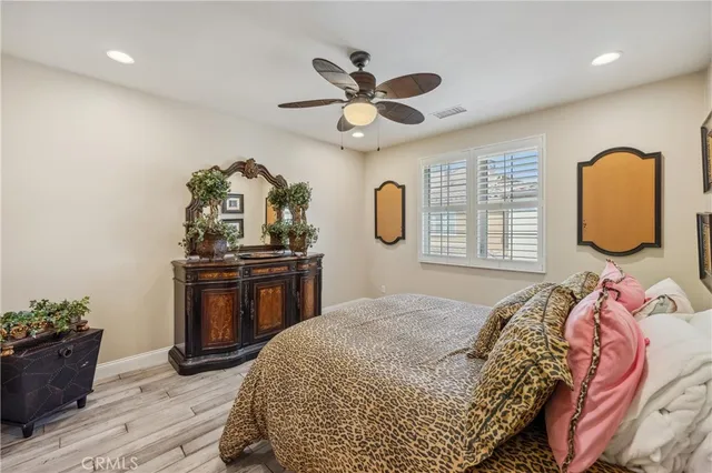 a bedroom with furniture and wooden floor