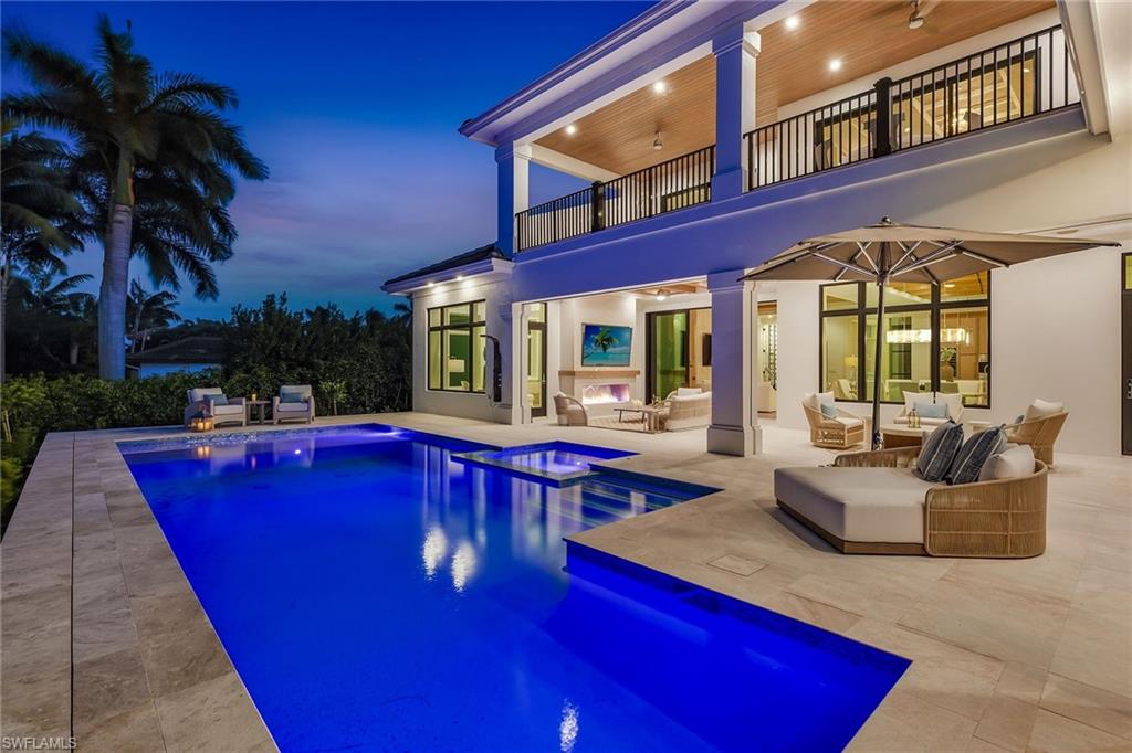 529 Neapolitan Way Naples, FL 34103 - Photo 12 of 26 a view of swimming pool with outdoor seating