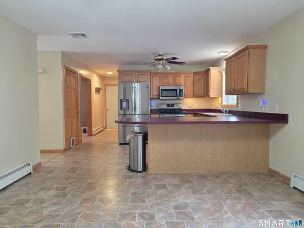a view of a kitchen with a sink and dishwasher cabinets
