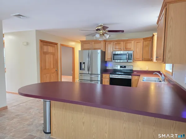 a kitchen with stainless steel appliances granite countertop a sink and cabinets