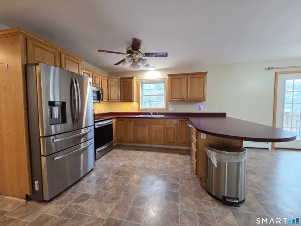 a kitchen with stainless steel appliances granite countertop a stove top oven a sink a counter space and cabinets