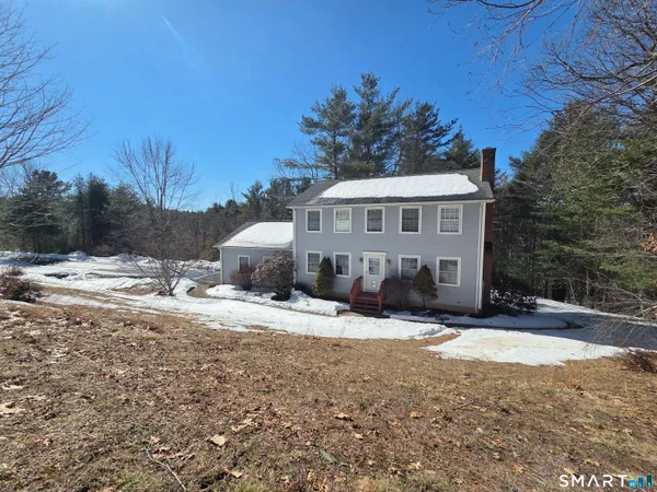 a view of a house with snow on the background