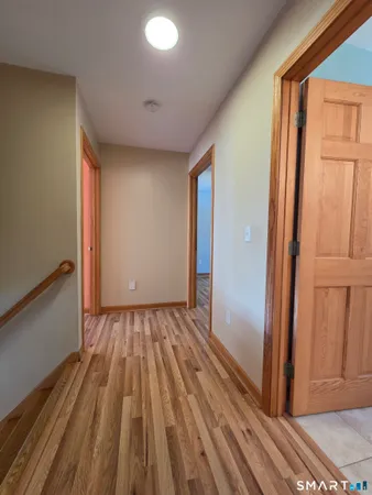 a spacious bathroom with a granite countertop sink a toilet and mirror