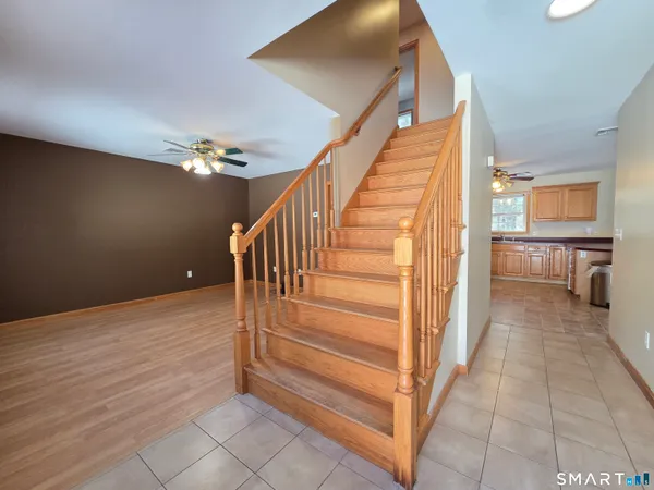 a view of entryway and hall with wooden floor