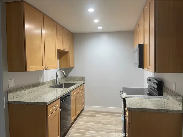 a kitchen with a sink and a mirror