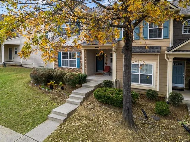 a front view of a house with a garden and plants