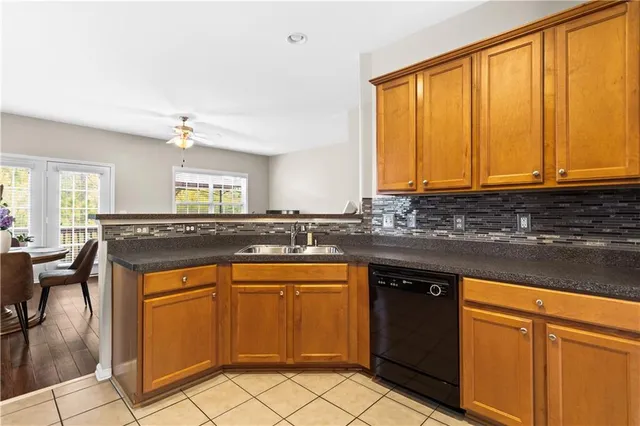 a living room with stainless steel appliances kitchen island granite countertop furniture and wooden floor