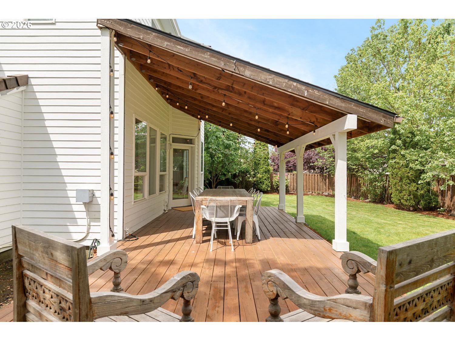 2519 Northwest 24th Circle Camas, WA 98607 - Photo 47 of 48 a view of a patio with table and chairs potted plants with wooden floor and fence