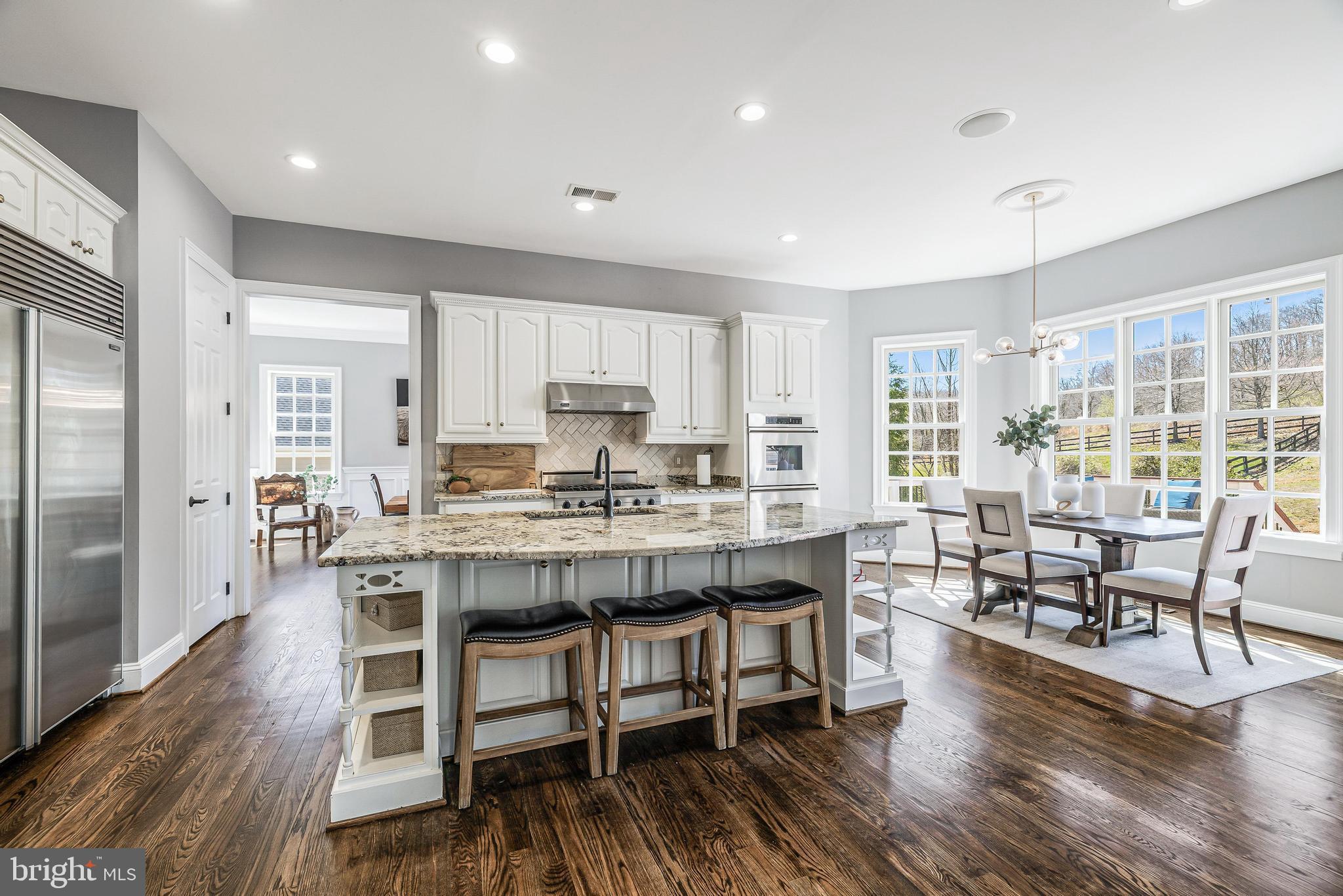 16319 Hunter Place Leesburg, VA 20176 - Photo 15 of 71 a living room with stainless steel appliances granite countertop furniture wooden floor and a view of kitchen