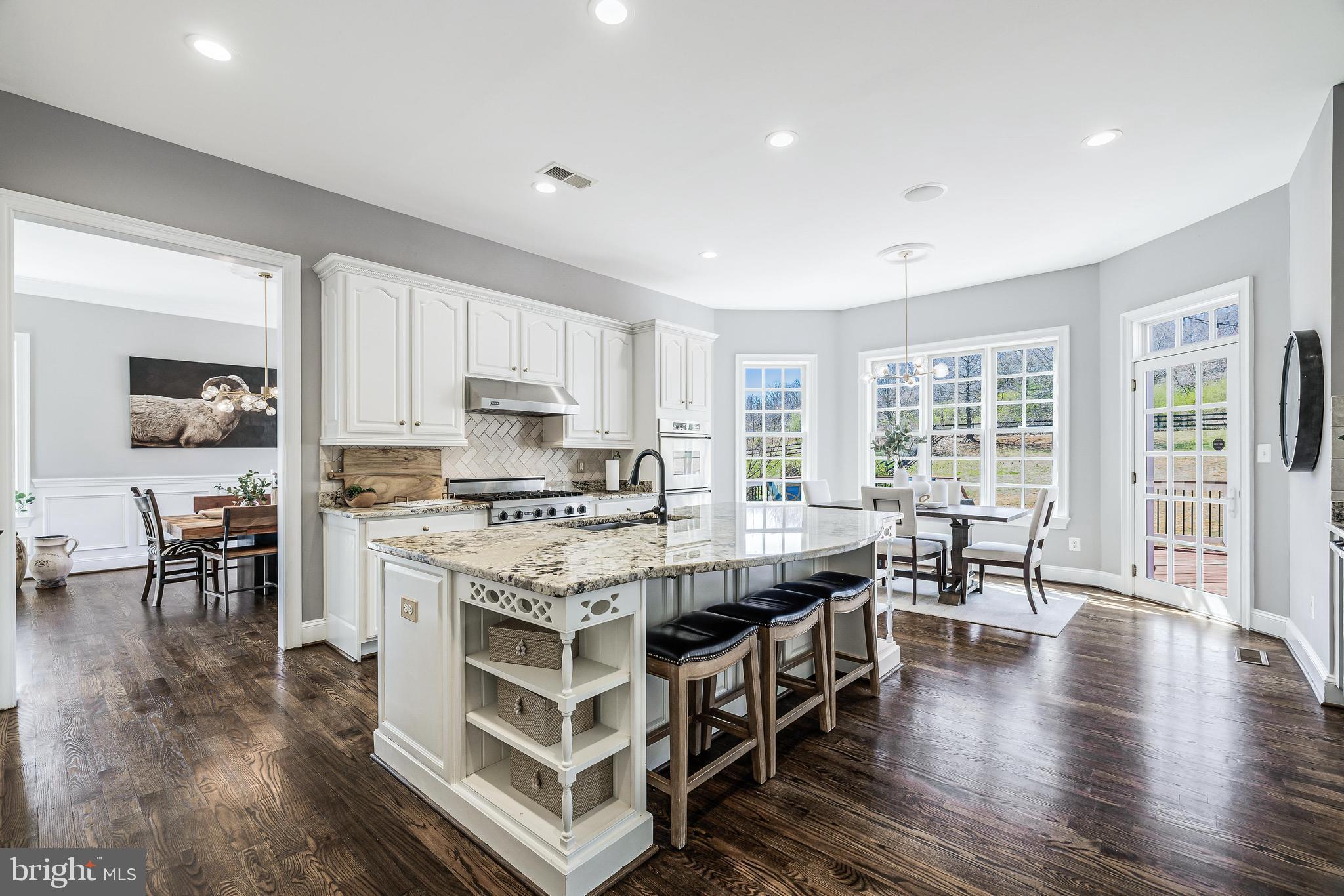 16319 Hunter Place Leesburg, VA 20176 - Photo 16 of 71 a large kitchen with a table and chairs in it
