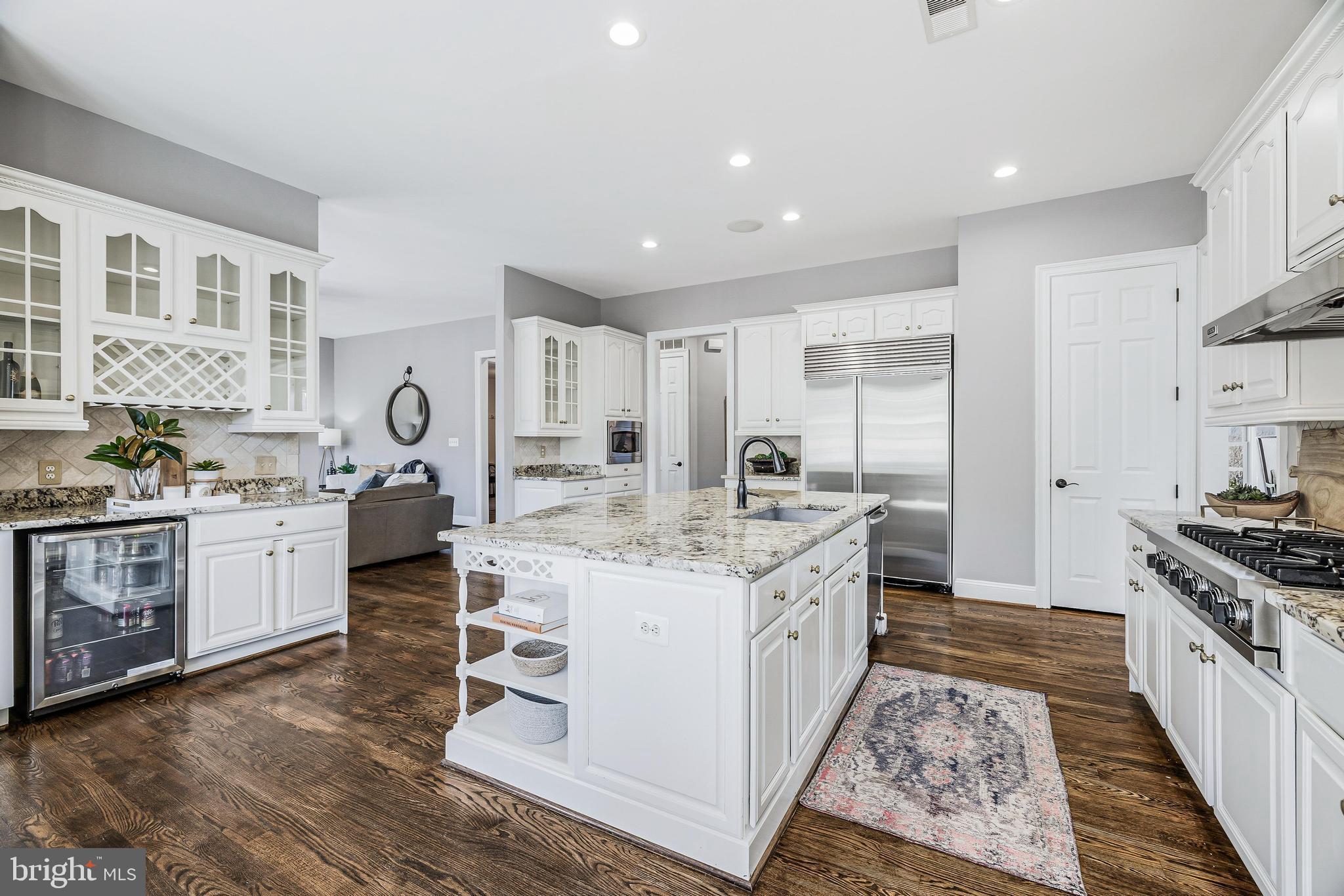 16319 Hunter Place Leesburg, VA 20176 - Photo 19 of 71 a kitchen with stainless steel appliances kitchen island granite countertop a stove a sink dishwasher and a refrigerator