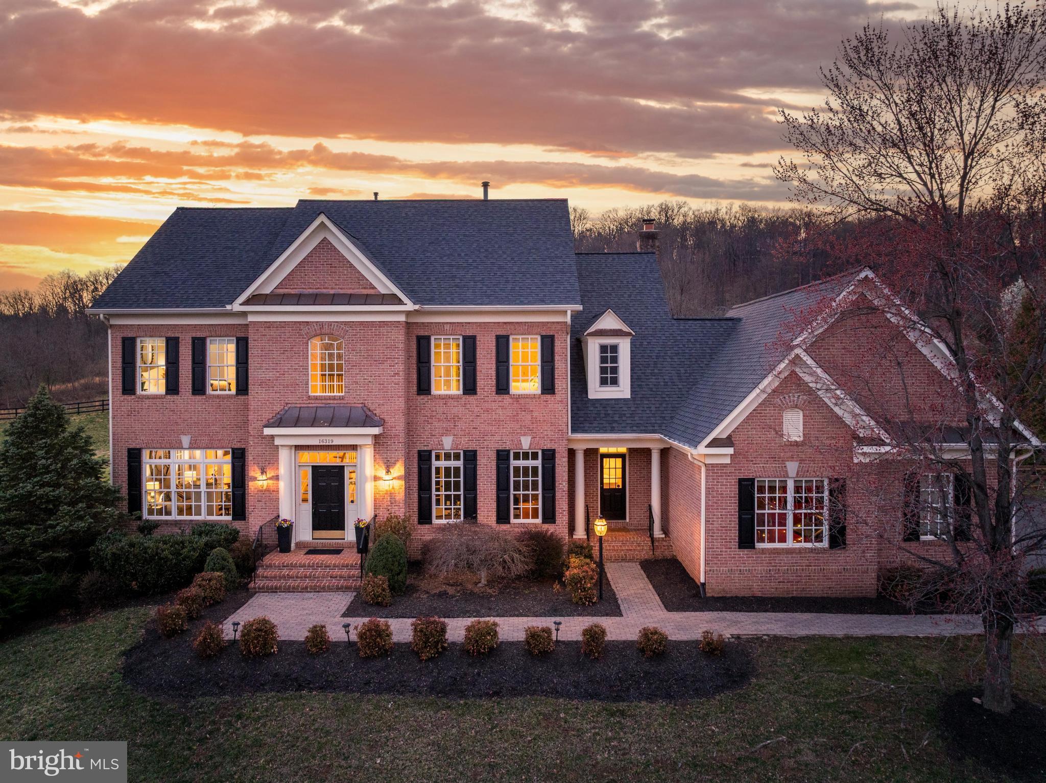 16319 Hunter Place Leesburg, VA 20176 - Photo 2 of 71 a front view of a house with a garden