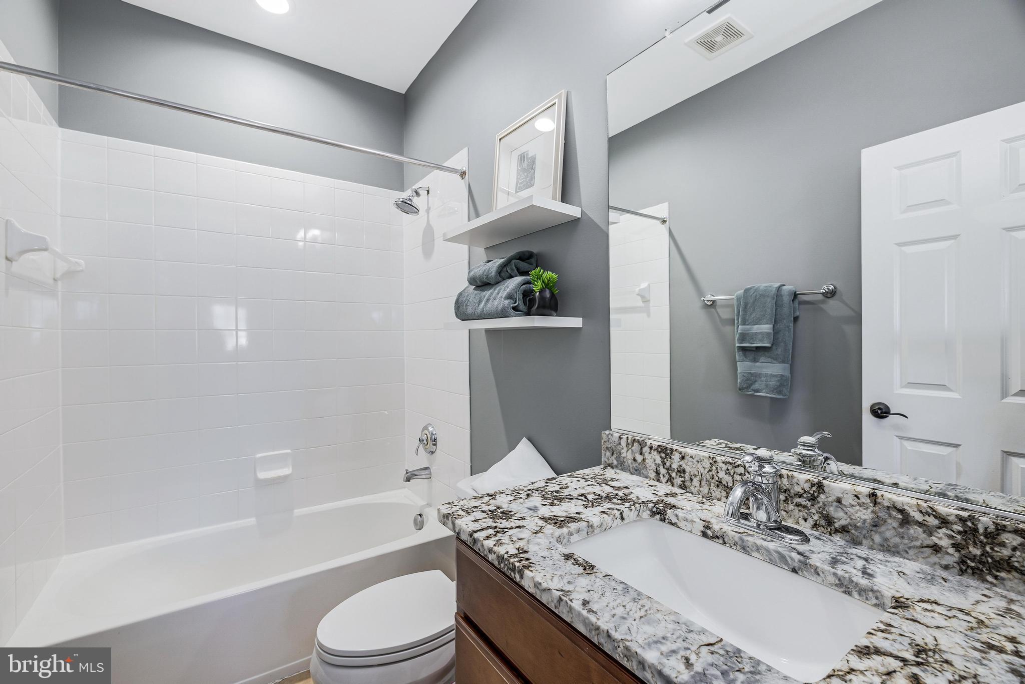 16319 Hunter Place Leesburg, VA 20176 - Photo 35 of 71 a bathroom with a granite countertop sink toilet and shower