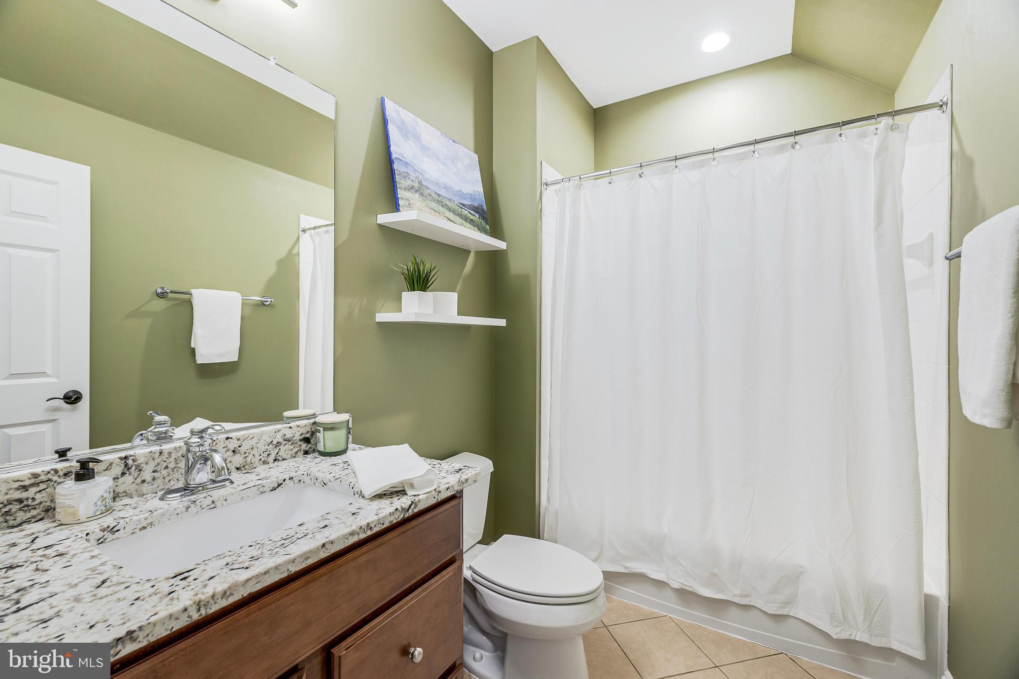 16319 Hunter Place Leesburg, VA 20176 - Photo 37 of 71 a bathroom with a granite countertop sink toilet and shower