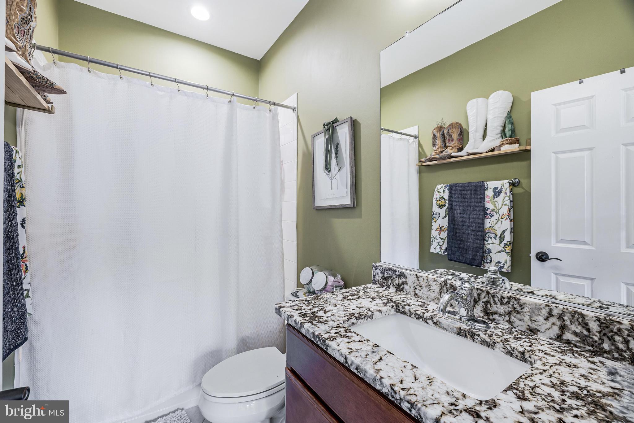 16319 Hunter Place Leesburg, VA 20176 - Photo 39 of 71 a bathroom with a granite countertop sink toilet and shower