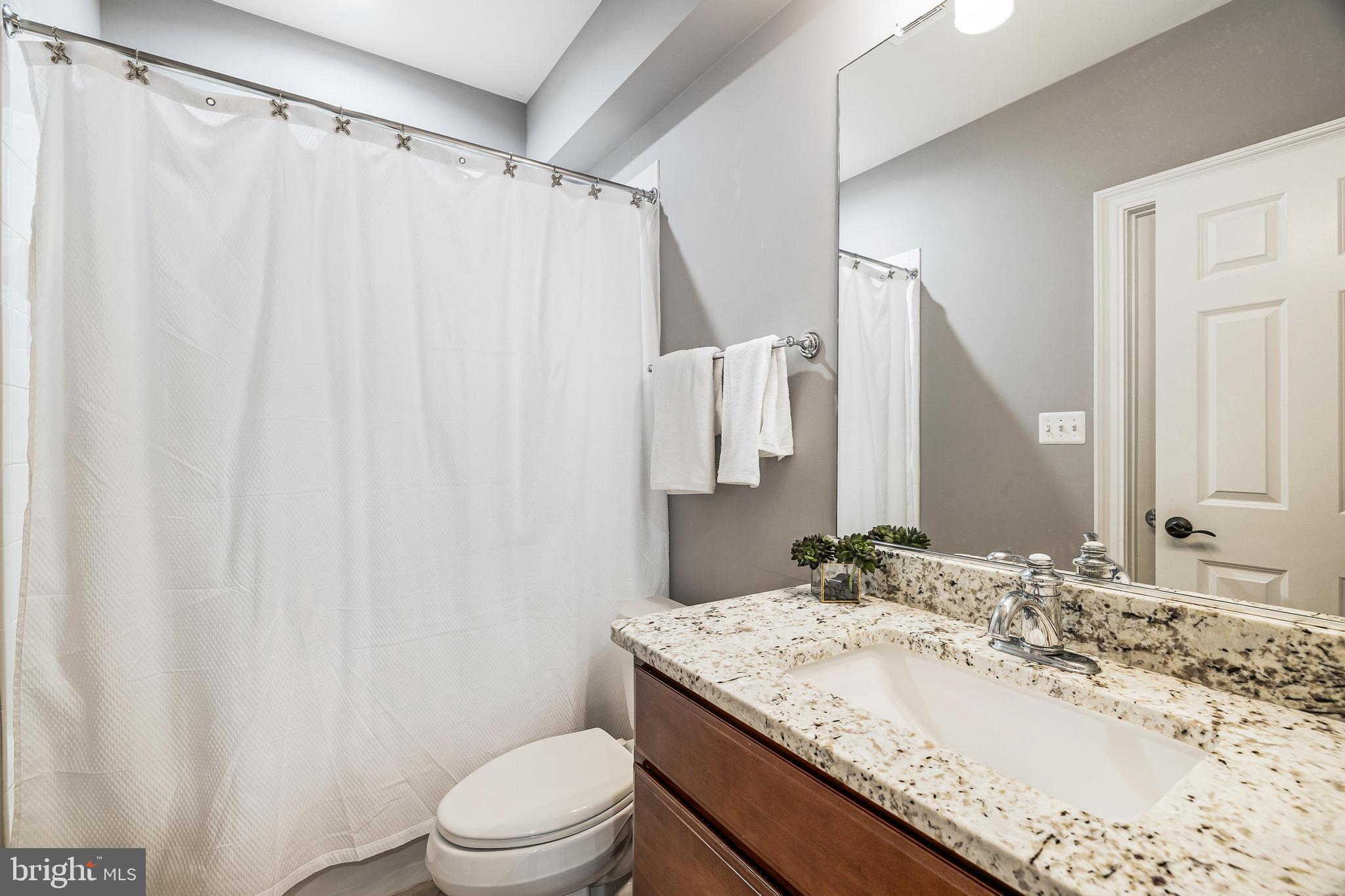 16319 Hunter Place Leesburg, VA 20176 - Photo 40 of 71 a bathroom with a granite countertop sink and a mirror