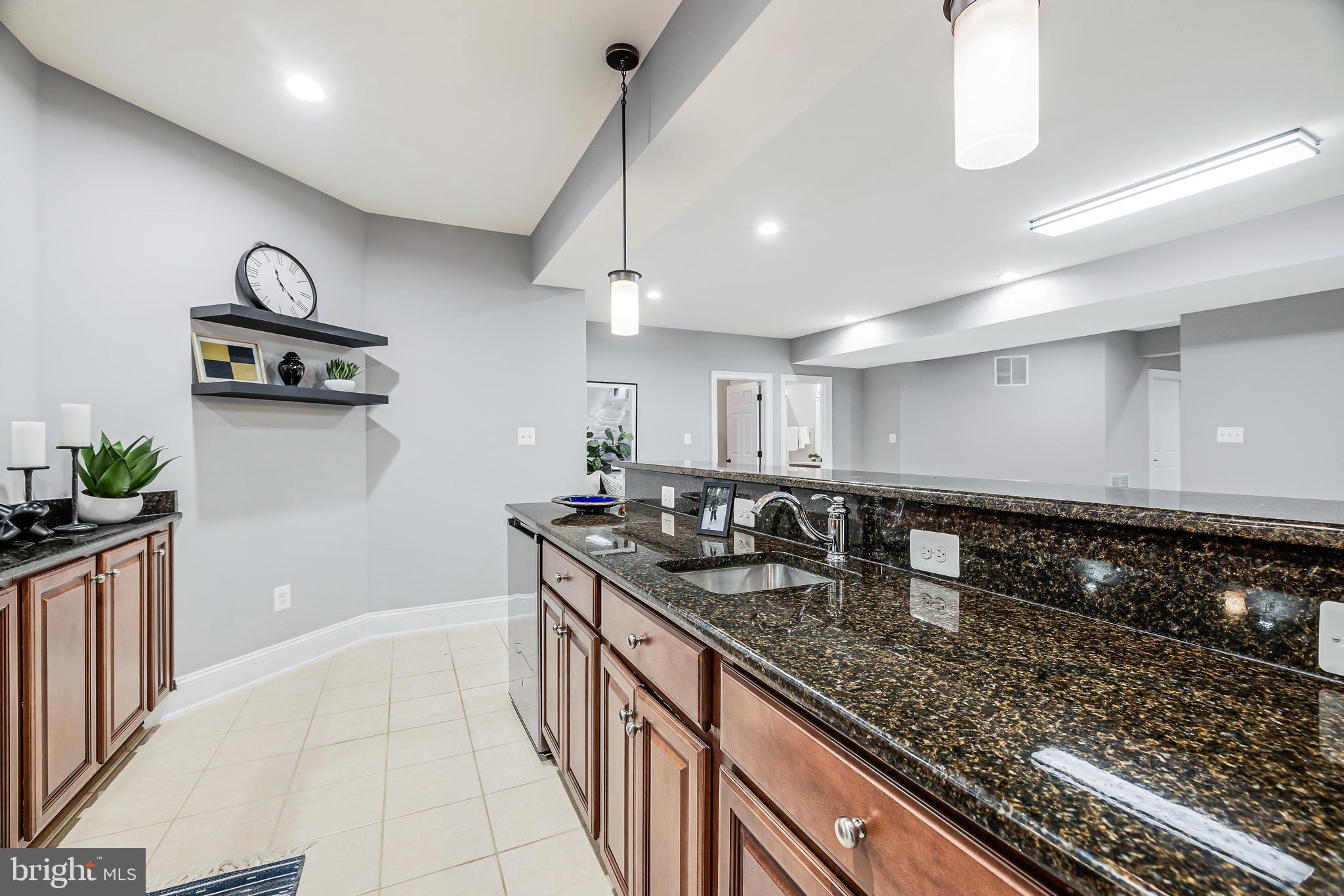 16319 Hunter Place Leesburg, VA 20176 - Photo 50 of 71 a kitchen with stainless steel appliances granite countertop a sink stove and cabinets