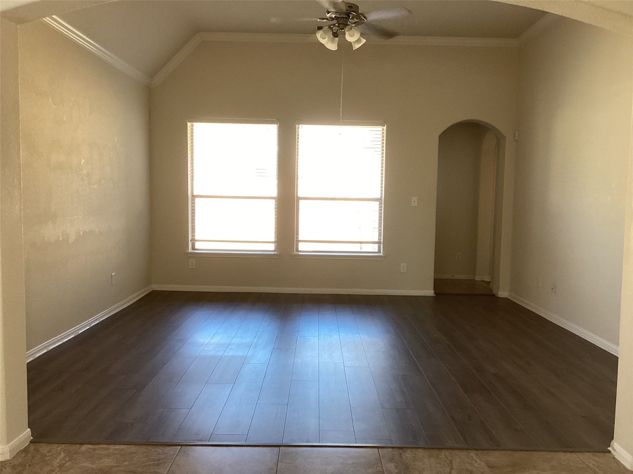 20122 Graphite Canyon Court Richmond, TX 77407 - Photo 11 of 27 Bright and inviting living room with elegant wood flooring and a charming archway, perfect for gatherings.