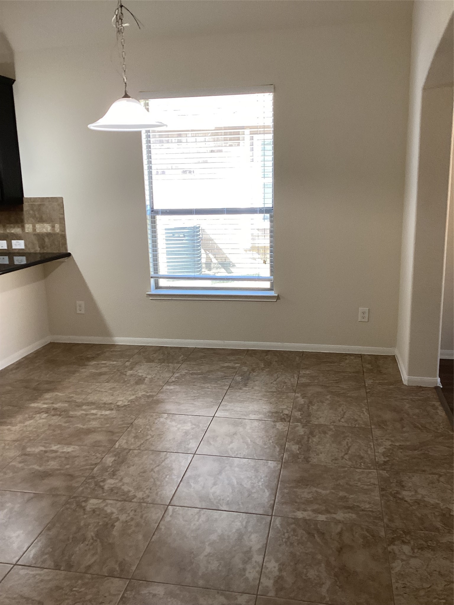 20122 Graphite Canyon Court Richmond, TX 77407 - Photo 5 of 27 Elegant dining room with tile flooring, large window for natural light, and a stylish fixture—ideal for gatherings.