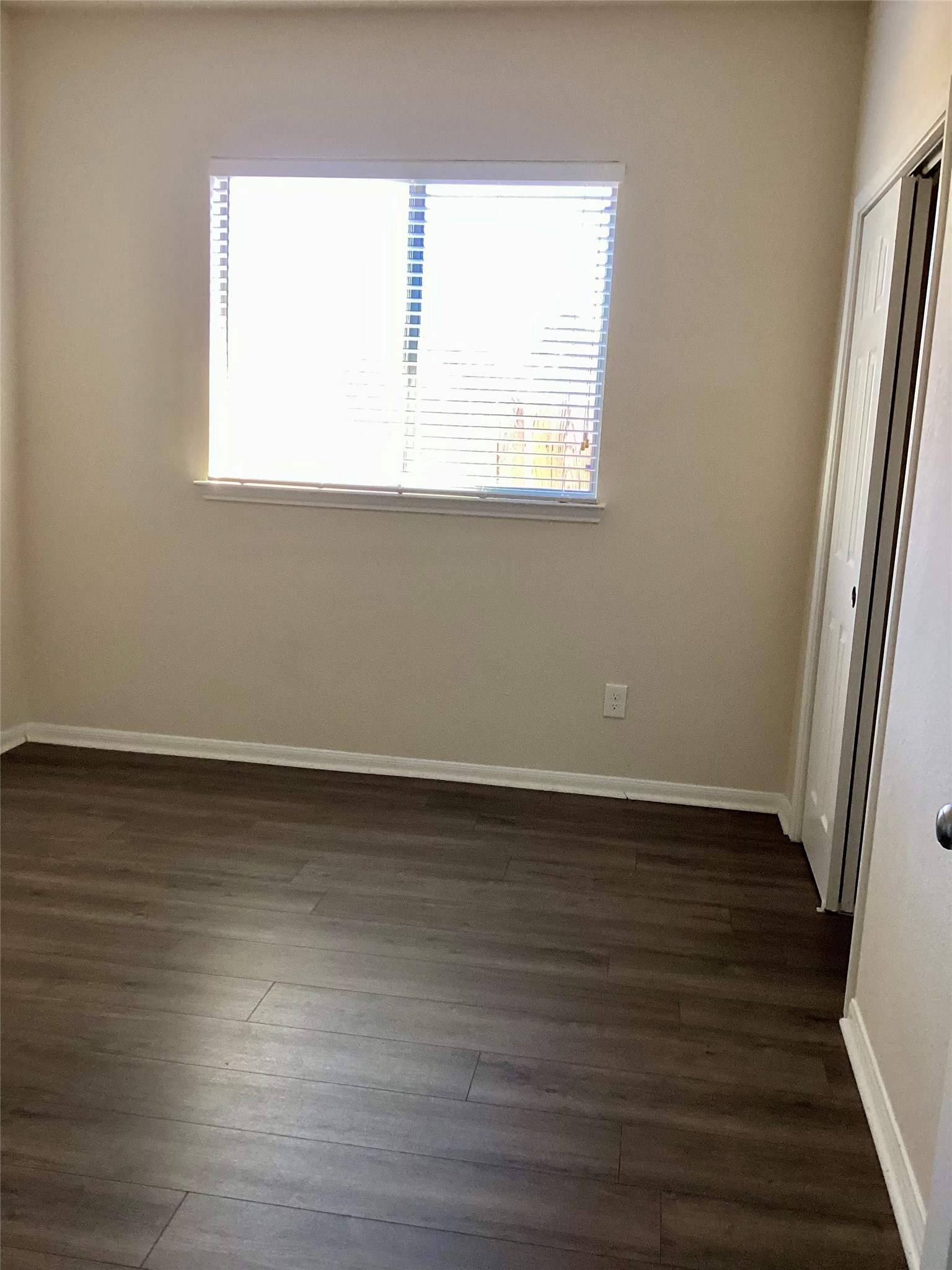 20122 Graphite Canyon Court Richmond, TX 77407 - Photo 8 of 27 Bright and cozy second bedroom with sleek hardwood floors and abundant natural light—ideal for relaxation or productivity.