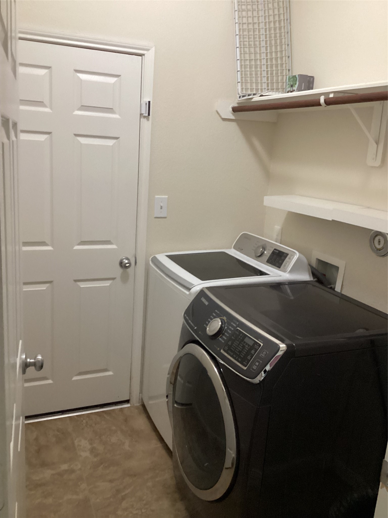 20122 Graphite Canyon Court Richmond, TX 77407 - Photo 10 of 27 Modern laundry room with sleek appliances and ample shelving for efficient organization.