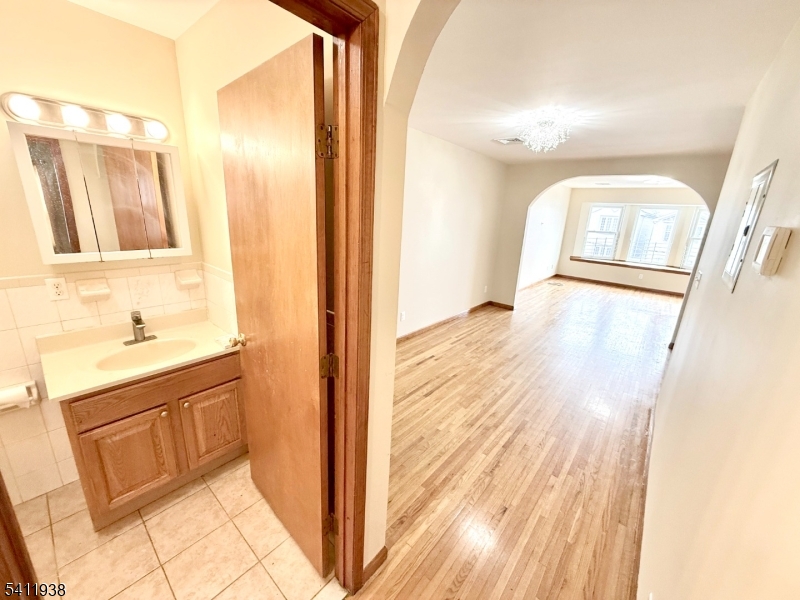 213 Palmer Street, Unit 2 Elizabeth, NJ 07202 - Photo 12 of 28 a bathroom with a sink mirror and a shower