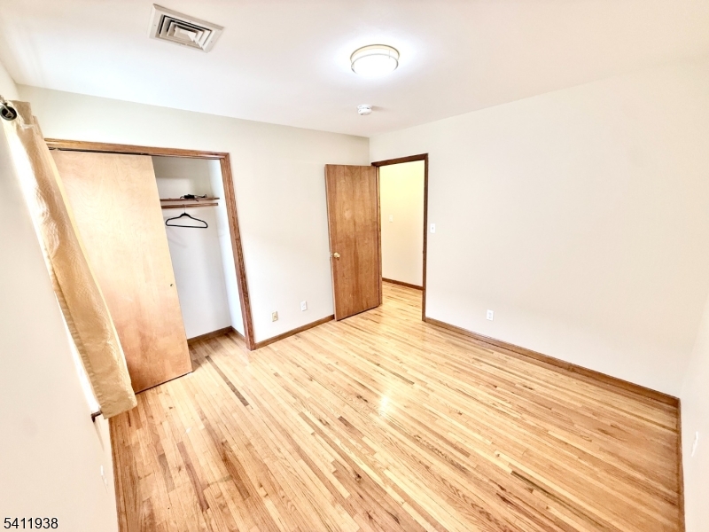 213 Palmer Street, Unit 2 Elizabeth, NJ 07202 - Photo 16 of 28 a view of empty room with wooden floor