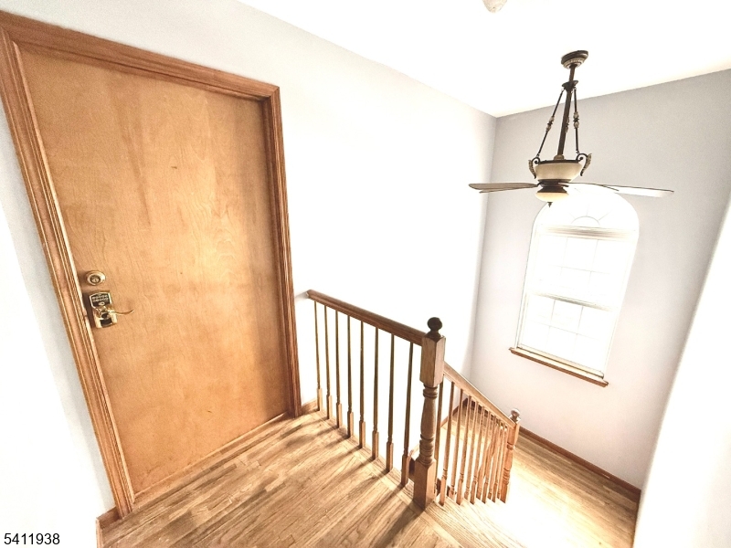 213 Palmer Street, Unit 2 Elizabeth, NJ 07202 - Photo 2 of 28 a view of a hallway with wooden floor and staircase