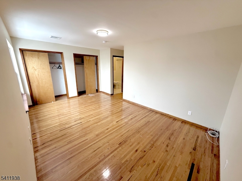 213 Palmer Street, Unit 2 Elizabeth, NJ 07202 - Photo 23 of 28 a view of empty room with wooden floor