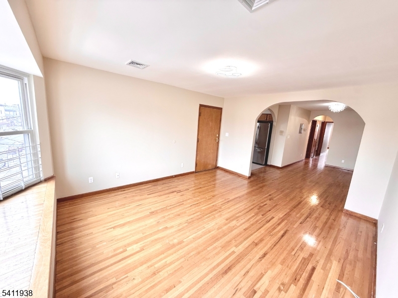 213 Palmer Street, Unit 2 Elizabeth, NJ 07202 - Photo 3 of 28 a view of a room with wooden floor