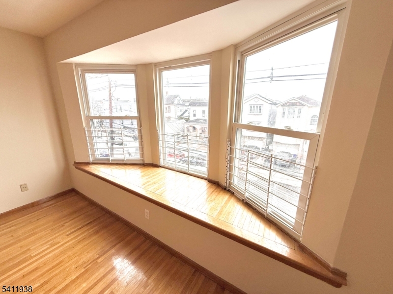 213 Palmer Street, Unit 2 Elizabeth, NJ 07202 - Photo 4 of 28 a big room with wooden floor and windows