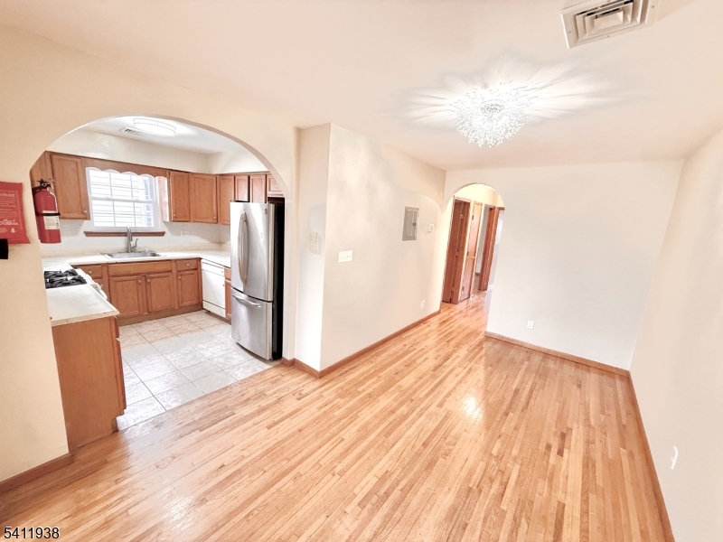 213 Palmer Street, Unit 2 Elizabeth, NJ 07202 - Photo 6 of 28 a view of kitchen with furniture and wooden floor