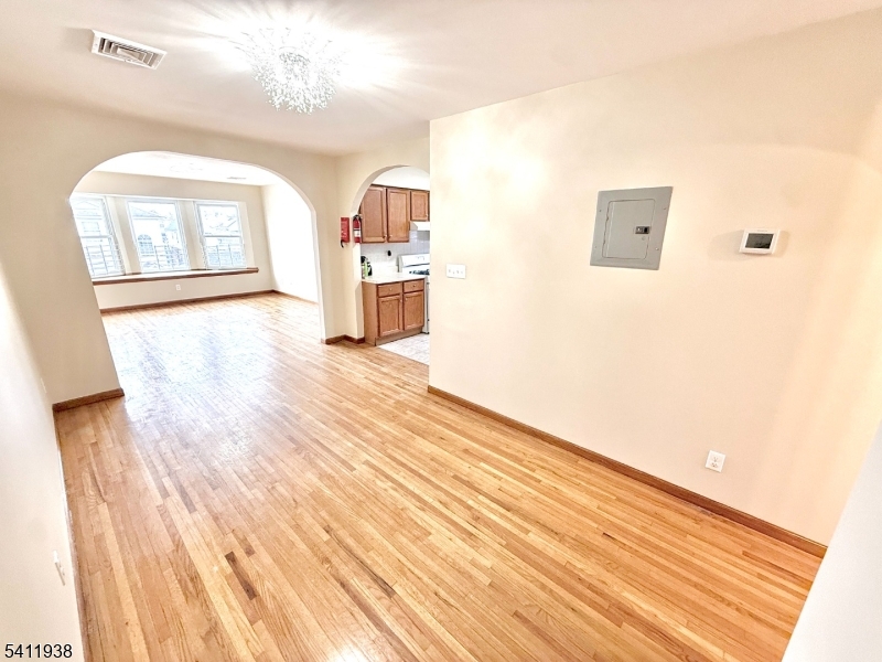213 Palmer Street, Unit 2 Elizabeth, NJ 07202 - Photo 7 of 28 a view of a room with wooden floor and cabinet