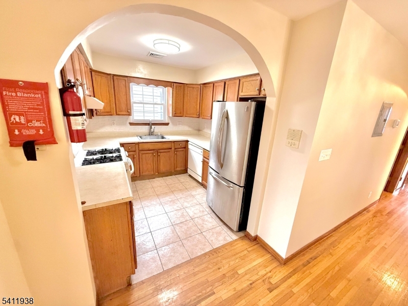 213 Palmer Street, Unit 2 Elizabeth, NJ 07202 - Photo 9 of 28 a kitchen with a refrigerator and a stove