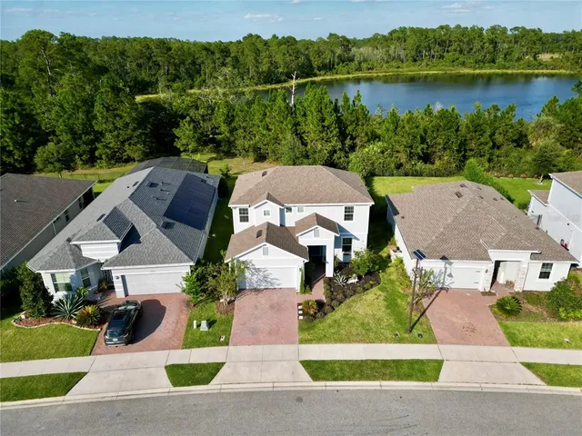 an aerial view of a house with a lake view