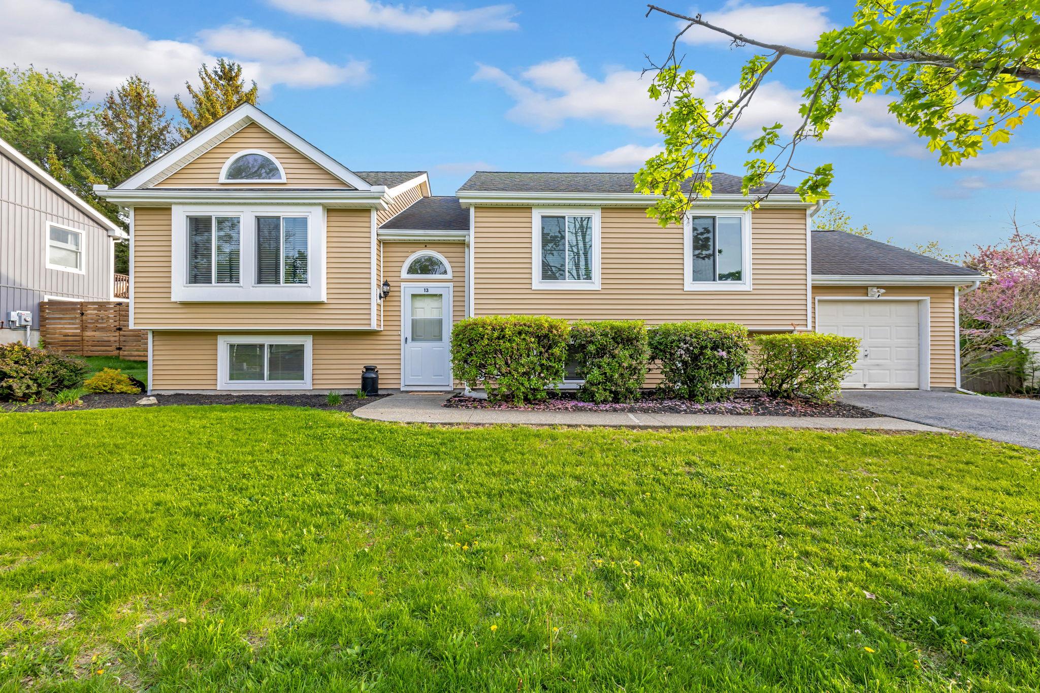 a front view of a house with a yard