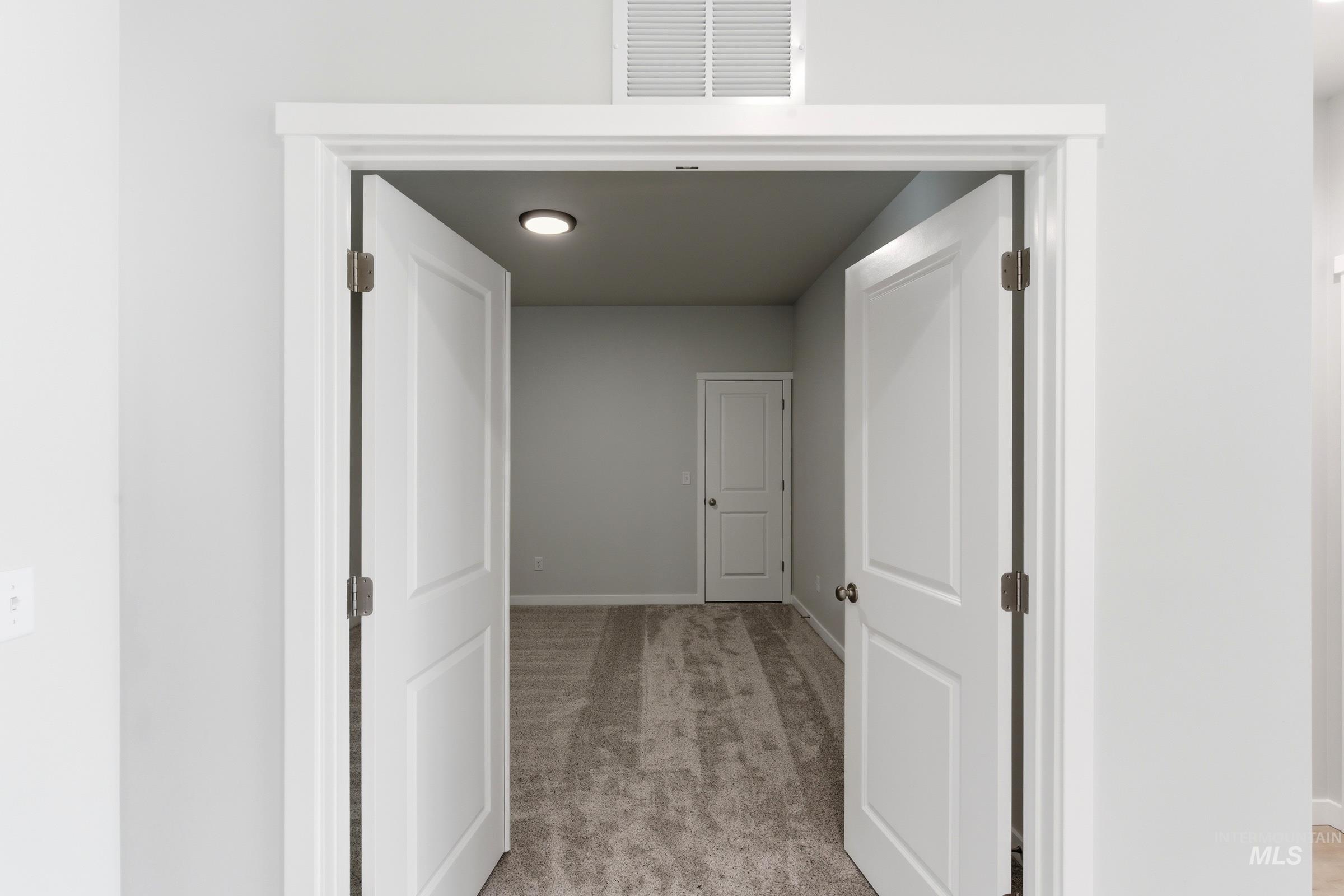 13663 Redway Court Caldwell, ID 83607 - Photo 16 of 32 Double panel doors opening into a carpeted interior space