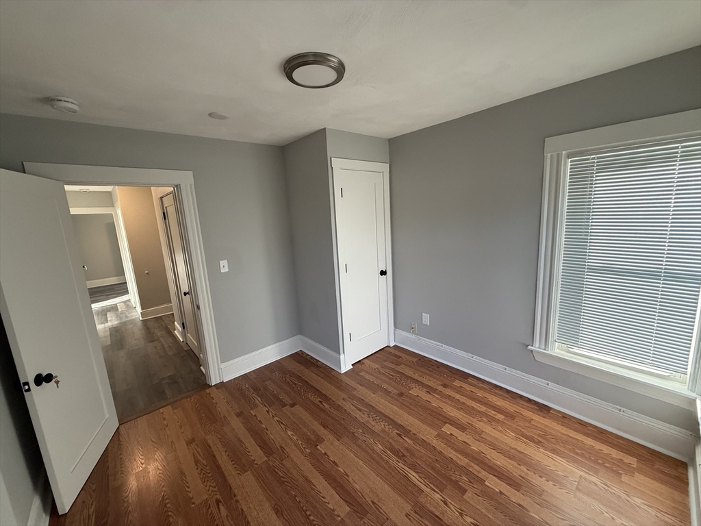 1922 Columbus Avenue, Unit 2 Boston, MA 02119 - Photo 12 of 22 a view of empty room with wooden floor